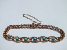 AN ANTIQUE YELLOW METAL CHAIN LINK BRACELET, the larger central links set with six turquoise