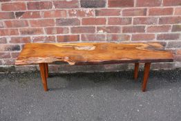 A MID 20TH CENTURY YEW WOOD COFFEE TABLE BY REYNOLDS OF LUDLOW, the shaped top raised on four