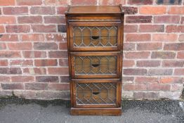 A 20TH CENTURY OAK GLAZED 'MINTY' THREE STAGE BOOKCASE OF SMALL PROPORTIONS, with six interior