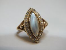 AN UNUSUAL MARQUISE CUT MOONSTONE MOURNING RING, surrounded by diamonds and having a removable back