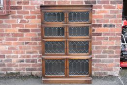 A 20TH CENTURY OAK GLAZED 'MINTY' FOUR STAGE BOOKCASE, H 142 cm, W 90 cm