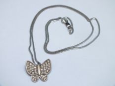 A SMALL MODERN BUTTERFLY PENDANT SET WITH CZ STONES, white metal stamped 585 and on a similar chain