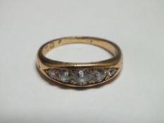 A HALLMARKED 18 CT GOLD FIVE STONE DIAMOND RING, set with good coloured graduating brilliant cut
