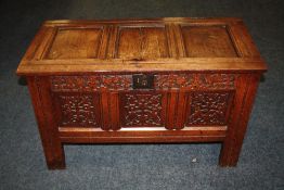 A LATE 18TH/EARLY 19TH CENTURY CARVED OAK COFFER OF SMALL PROPORTIONS, the hinged lid with