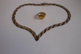AN 18ct GOLD SIGNET RING, together with a three colour silver wishbone necklace.
