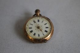 A SMALL CONTINENTAL ENAMELLED YELLOW METAL FOB WATCH, decorated to the back with a lake scene with a