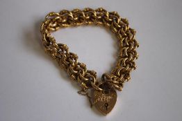 AN EDWARDIAN TRIPLE FANCY LINK BRACELET, with a heart padlock clasp marked 15ct