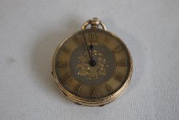 A YELLOW METAL (MARKED 14ct) OPEN FACE FOB WATCH, gilt engraved dial with applied markings.