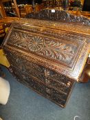AN ANTIQUE CARVED OAK BUREAU WITH MASK HANDLES - W 93 CM