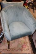 A MODERN UPHOLSTERED TUB CHAIR