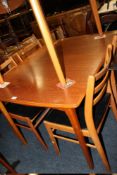 A RETRO TEAK EXTENDING DINING TABLE WITH FOUR CHAIRS