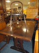 AN OAK REFECTORY STYLE TABLE WITH FOUR HOOP BACK CHAIRS