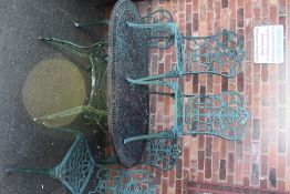 A PAINTED GREEN METAL GARDEN TABLE AND 5 CHAIRS