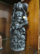 AN TRIBAL STYLE EBONISED CARVING