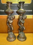 A PAIR OF LARGE COPPER EFFECT FIGURATIVE CANDLESTICKS