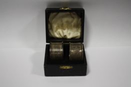 A PAIR OF BOXED HALLMARKED SILVER NAPKIN RINGS