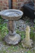 A FLORAL DESIGN BIRDBATH TOGETHER WITH A LIGHTHOUSE ORNAMENT