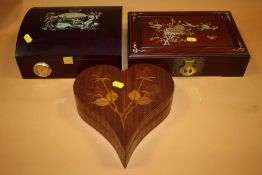 AN INLAID HEART SHAPED JEWELLERY BOX, TOGETHER WITH A MOTHER OF PEARL INLAID EXAMPLE AND A CIGAR
