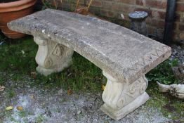A RECONSTITUTED STONE GARDEN PEDESTAL BENCH