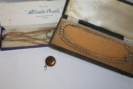 A RETRACTABLE CHAIN TOGETHER WITH TWO CASED SETS OF FAUX PEARLS