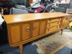 A RETRO TEAK SIDEBOARD WITH THREE DRAWERS & TWO CUPBOARDS W 197 CM
