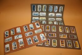 THREE VINTAGE ALBUMS OF CIGARETTE CARDS TO INCLUDE WAR RELATED EXAMPLES