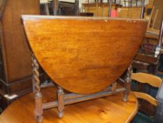 AN OAK BARLEYTWIST DROPLEAF TABLE