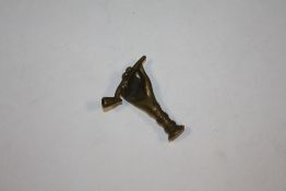 A VINTAGE BRASS PIPE TAMPER IN THE FORM OF A HAND