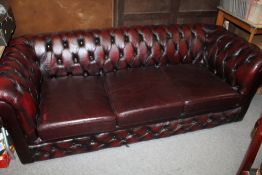 AN OXBLOOD RED LEATHER CHESTERFIELD