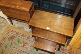 A NEST OF THREE TABLES TOGETHER WITH A STRIPED SUTHERLAND TABLE
