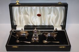 A CASED HALLMARKED SILVER CRUET SET
