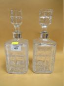 A PAIR OF CUT GLASS DECANTERS WITH 925 STERLING SILVER COLLARS