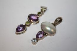 TWO SILVER AND GEMSET PENDANTS