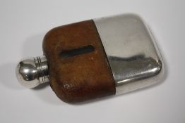 A SILVER PLATED AND GLASS HIP FLASK