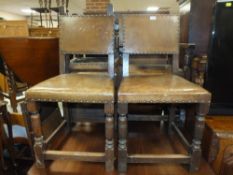A SET OF SIX OAK LEATHER / STUDDED DINING CHAIRS