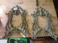 A PAIR OF VINTAGE BRASS PIERCED ANGELIC SHAPED PICTURE FRAMES