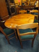 A HONEY PINE DROPLEAF TABLE AND FOUR CHAIRS