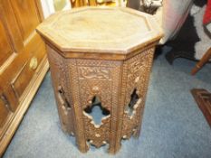 AN OCTAGONAL HEAVILY CARVED EASTERN SIDE TABLE