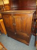 AN OAK LINENFOLD TELEVISION CABINET