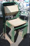 A SET OF SEVEN METAL FRAMED STACKING CHAIRS