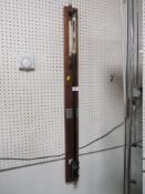 A VINTAGE CYLINDRICAL WALL MOUNTED BAROMETER