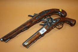 A REPRODUCTION DOUBLE BARREL DECORATIVE FLINT LOCK PISTOL TOGETHER WITH A SINGLE BARREL EXAMPLE