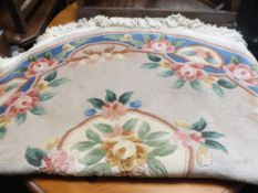 A FLORAL CIRCULAR RUG