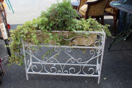 A WROUGHT IRON VINTAGE PLANTER ON STAND PLUS CONTENTS