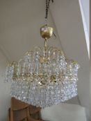 A MODERN GILT CRYSTAL CHANDELIER