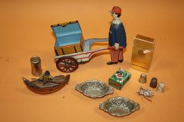 A BOX OF COLLECTABLES TO INCLUDE A WIND UP TIN PLATE MAN AND CART, SPELTER STYLE FISHERMAN ETC