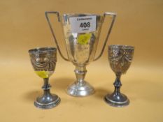 A HALLMARKED SILVER TROPHY TOGETHER WITH A PAIR OF H/M SILVER EGG CUPS,