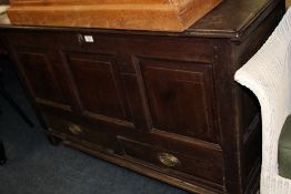 AN ANTIQUE OAK PANELLED MULE CHEST, the original hinged lid above a triple panel front and two
