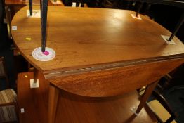 A RETRO TEAK DROP LEAF TABLE WITH FOUR CHAIRS