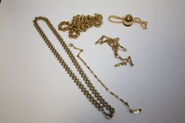 A BAG OF UNMARKED YELLOW METAL TO INCLUDE A NECKLACE AND BRACELET SET AND A JOCKEY CAP AND WHIP